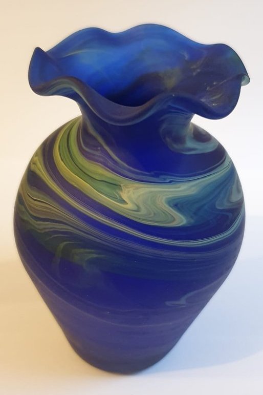 Round, flare-necked blue marbled glass vase
