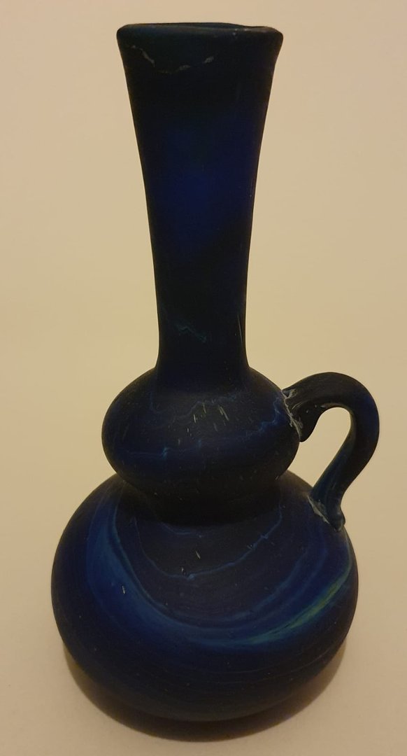 Rounded, segmented, long flared neck. blue marbled glass vase